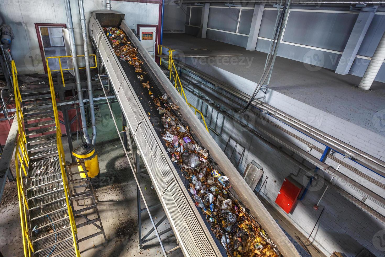 moving conveyor transporter on Modern waste recycling processing plant. Separate and sorting garbage collection. Recycling and storage of waste for further disposal. photo