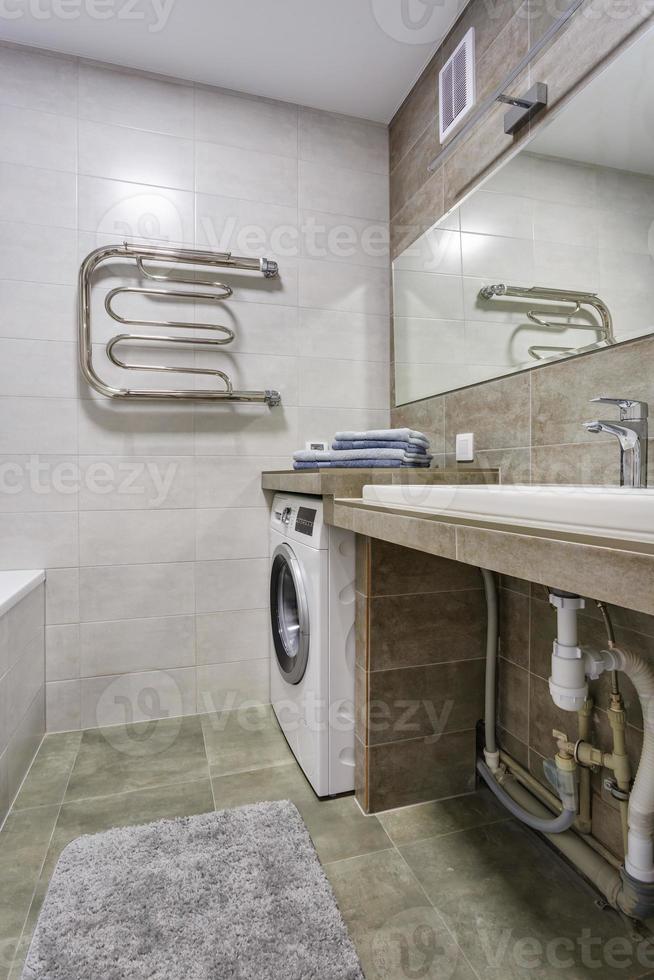 water tap sink with faucet in expensive loft bathroom. detail of a corner shower cabin with wall mount shower attachment photo