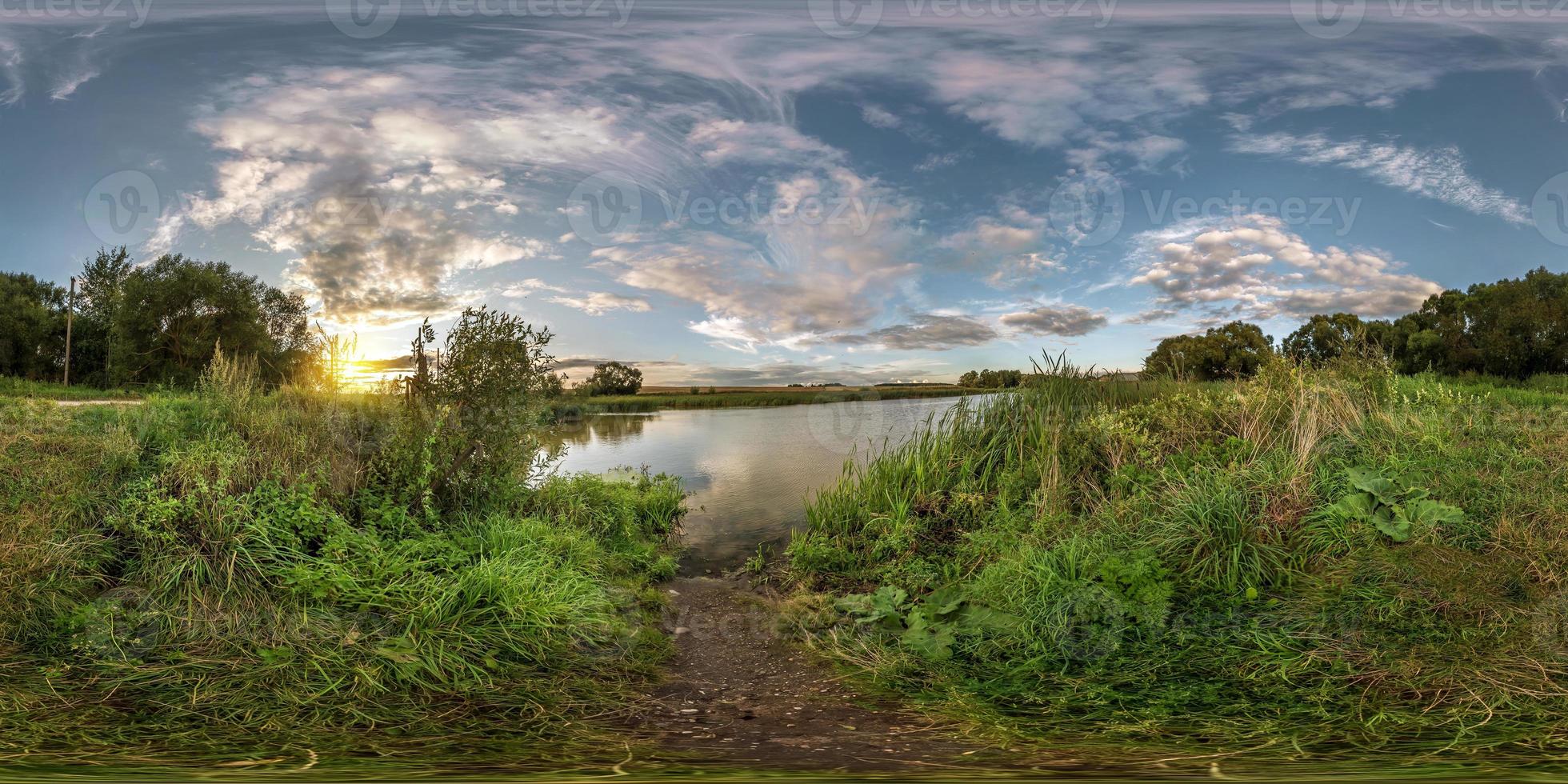 full seamless spherical panorama 360 by 180 angle view on the shore of small lake in sunny summer evening with awesome clouds in equirectangular projection, skybox VR virtual reality content photo