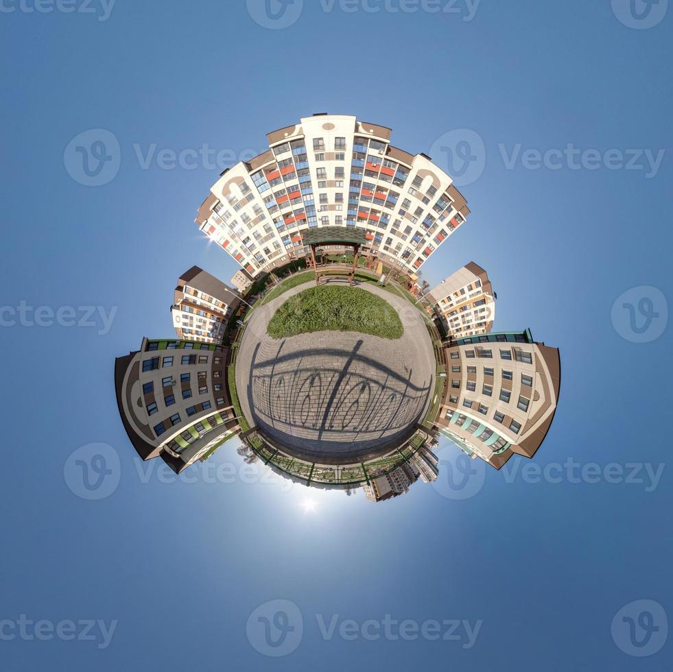 tiny planet in blue sky with clouds in city center near modern skyscrapers or office buildings. Transformation of spherical 360 panorama in abstract aerial view. photo