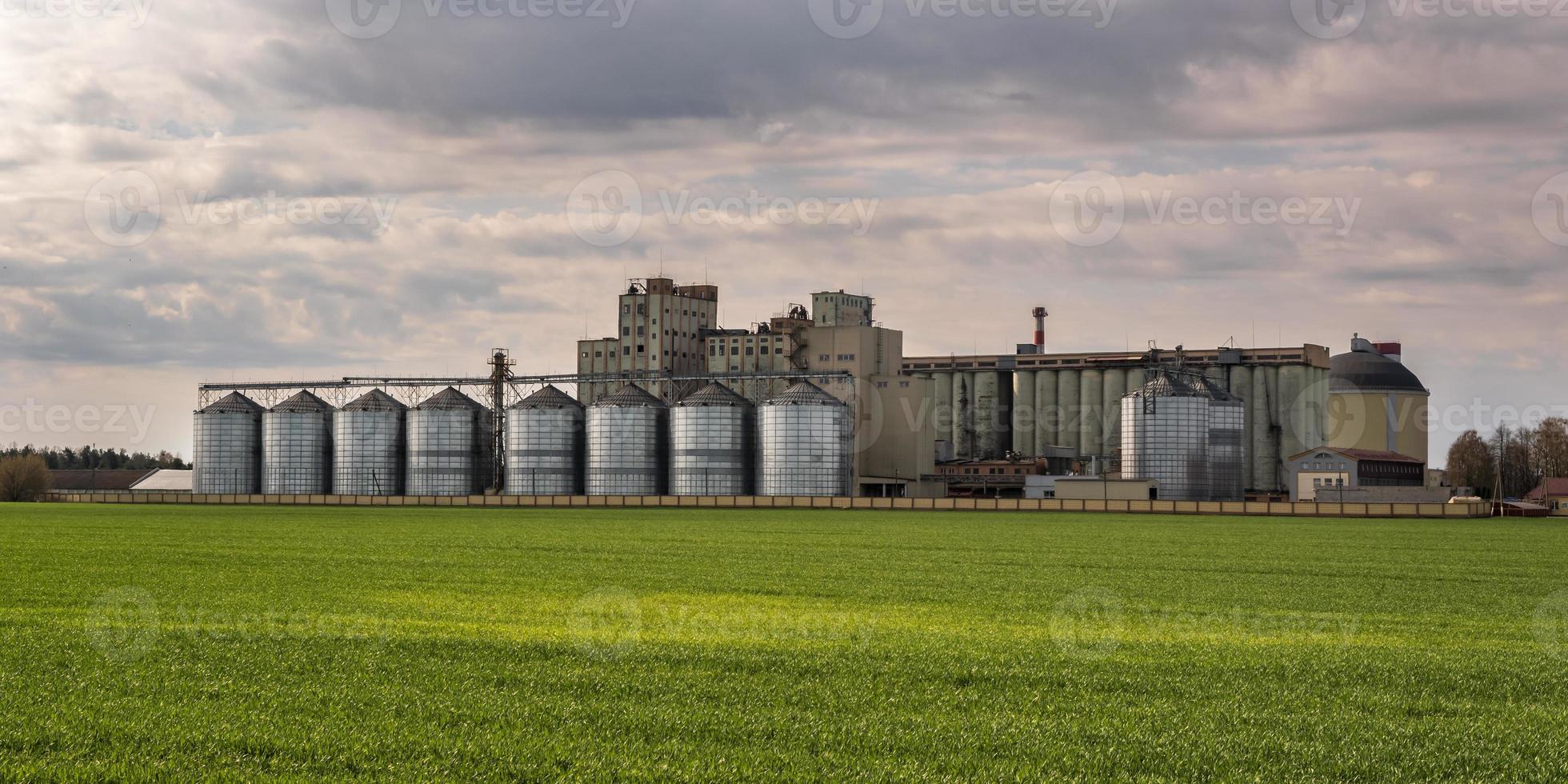 agro silos granary elevator on agro-processing manufacturing plant for processing drying cleaning and storage of agricultural products, flour, cereals and grain. photo