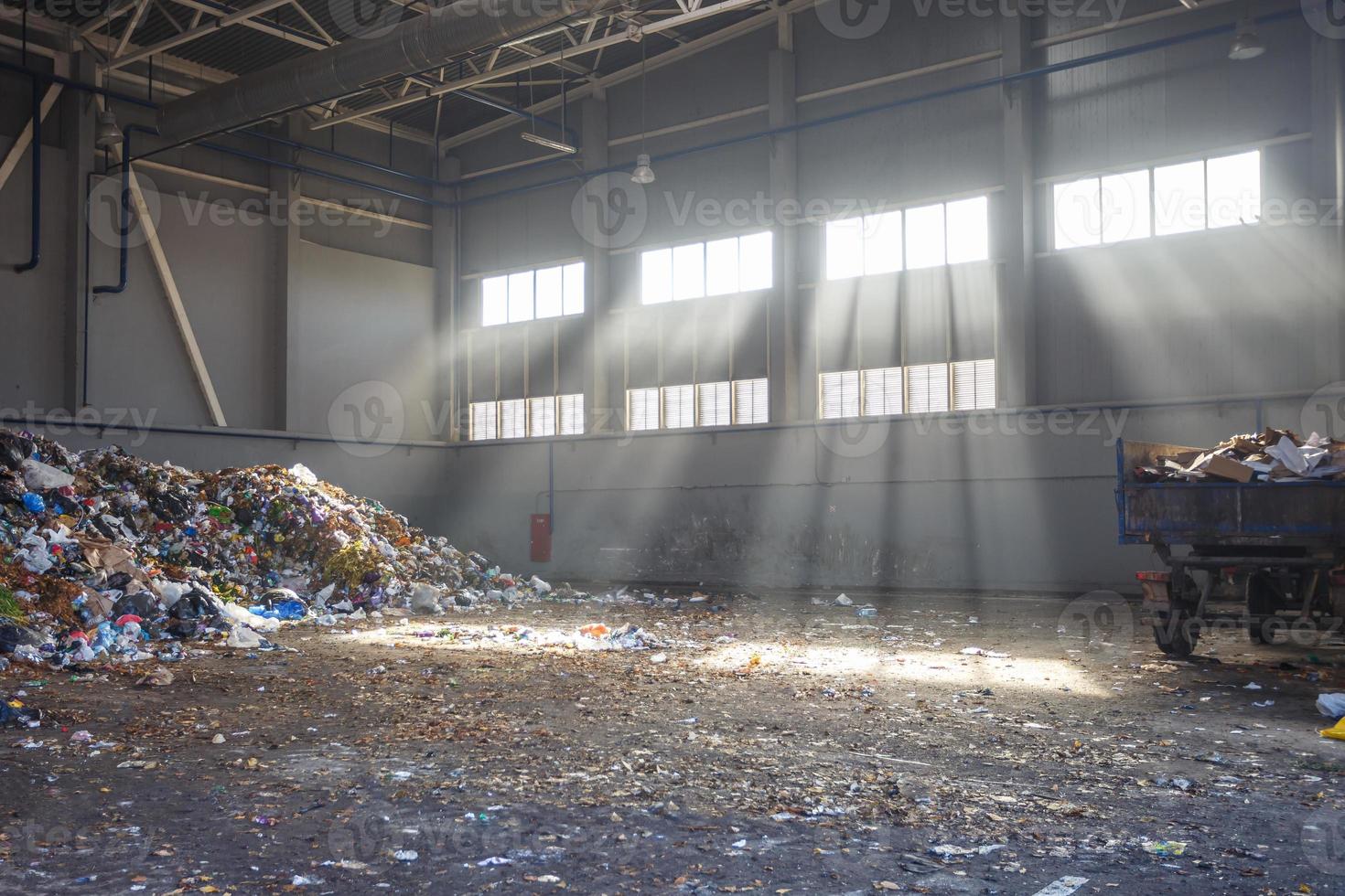 trash sorting and recycling workshop with trailer at the waste processing plant with sun rays. Separate garbage collection. Recycling and storage of waste for further disposal. photo