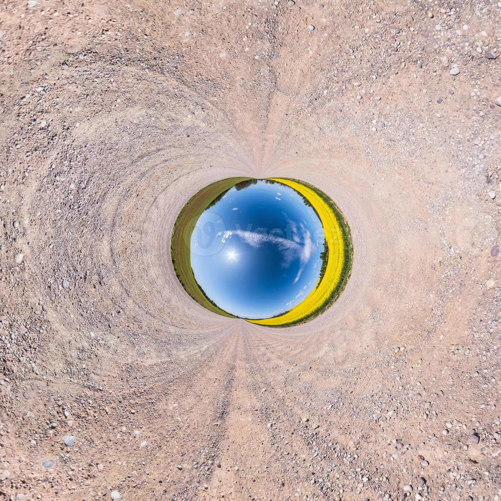 Little planet transformation of spherical panorama 360 degrees. Spherical abstract aerial view in field with awesome beautiful clouds. Curvature of space. photo
