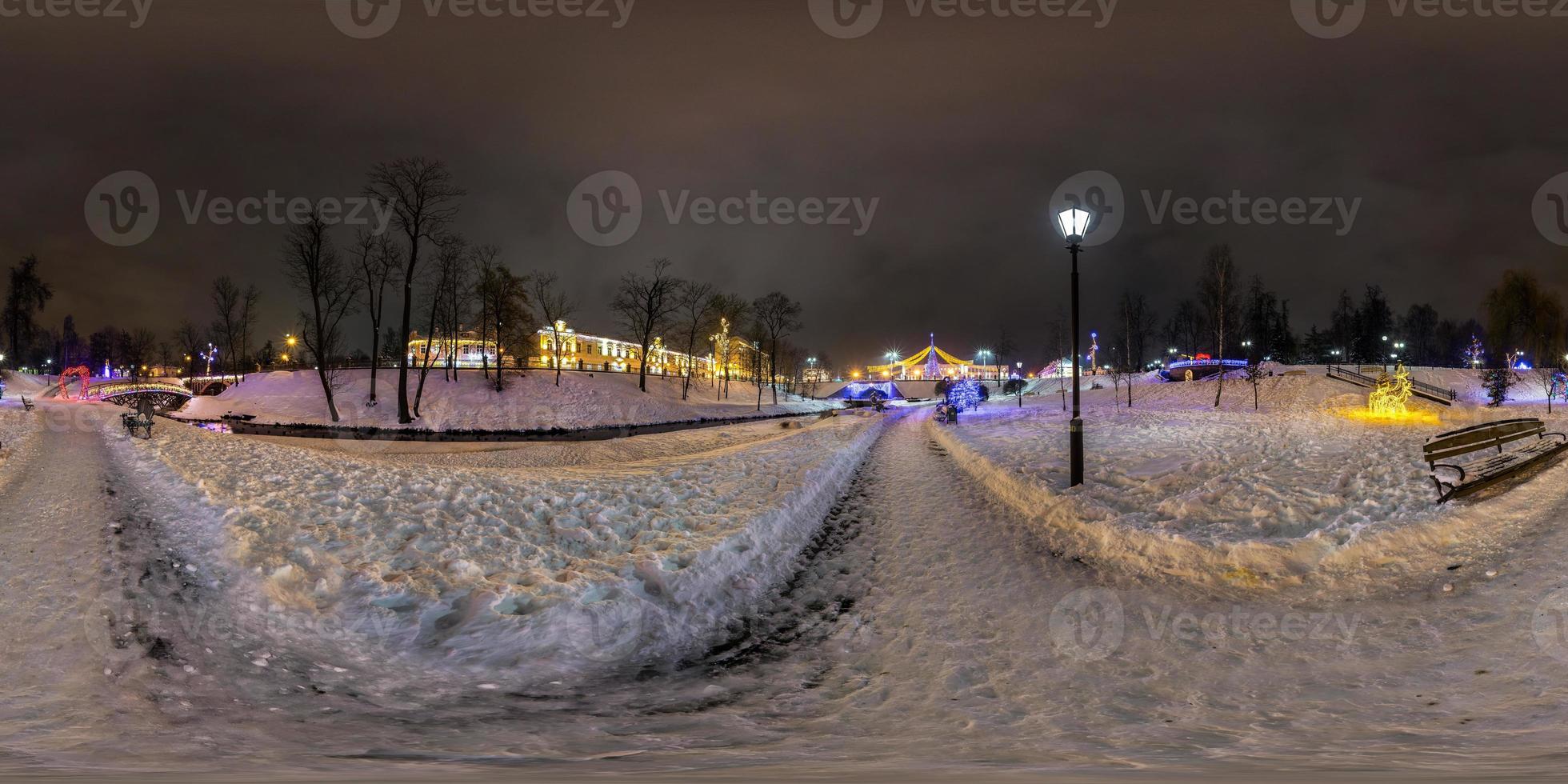 winter full spherical seamless panorama 360 degrees angle view in night park with new year illumination in equirectangular equidistant projection. VR AR content photo