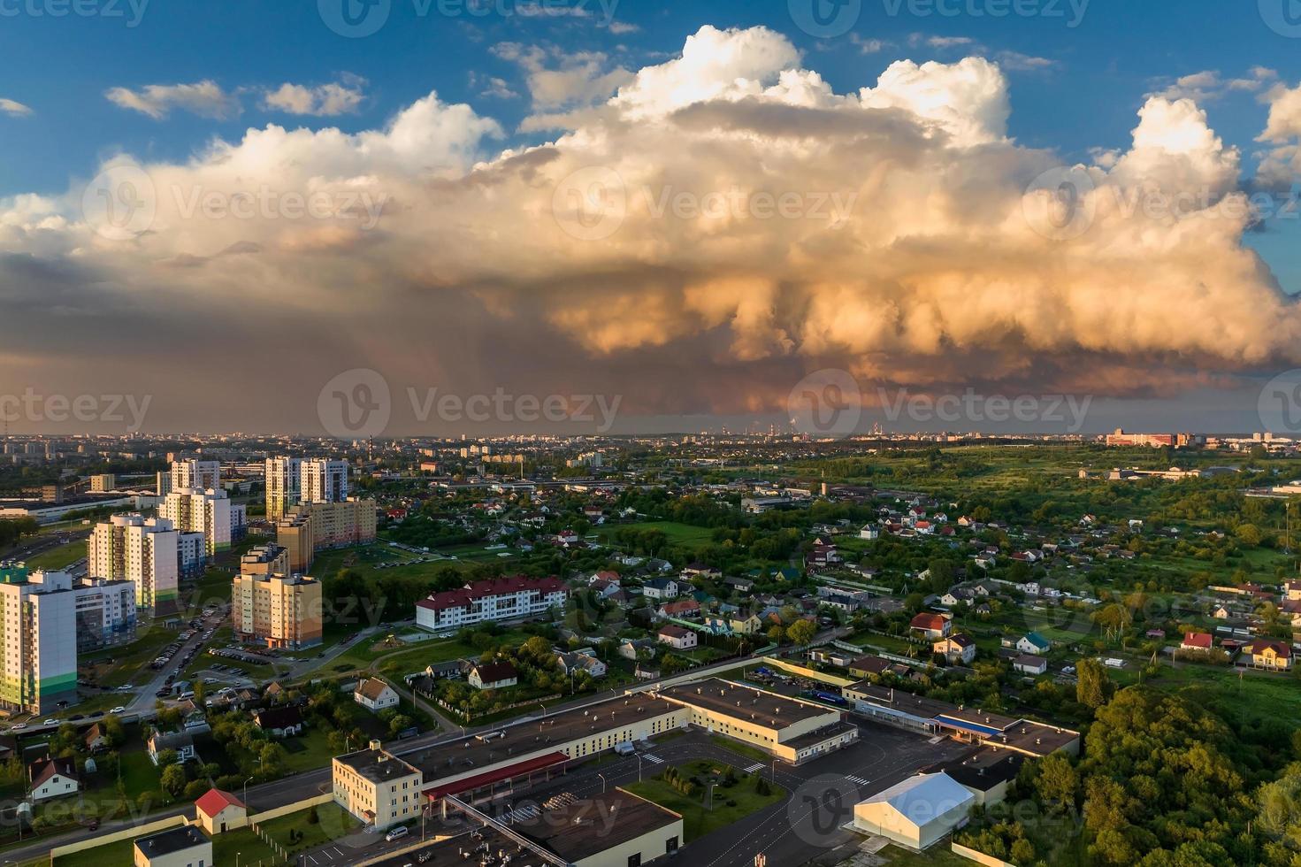 ariel panoramic view of city and skyscrapers with a huge factory with smoking chimneys in the background photo