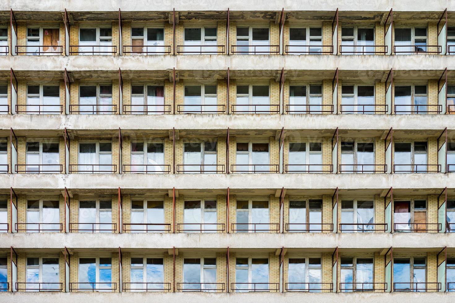 rows of windows in fasade of an abandoned building photo