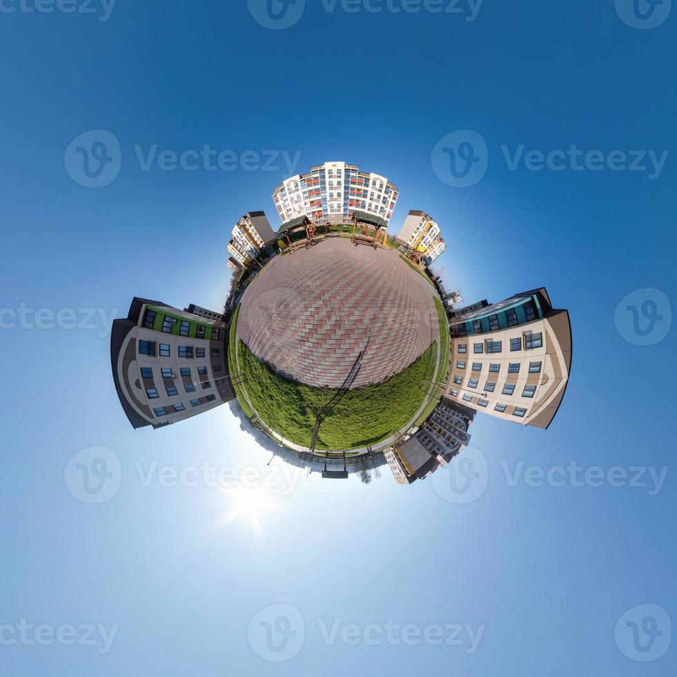 tiny planet in blue sky with clouds in city center near modern skyscrapers or office buildings. Transformation of spherical 360 panorama in abstract aerial view. photo