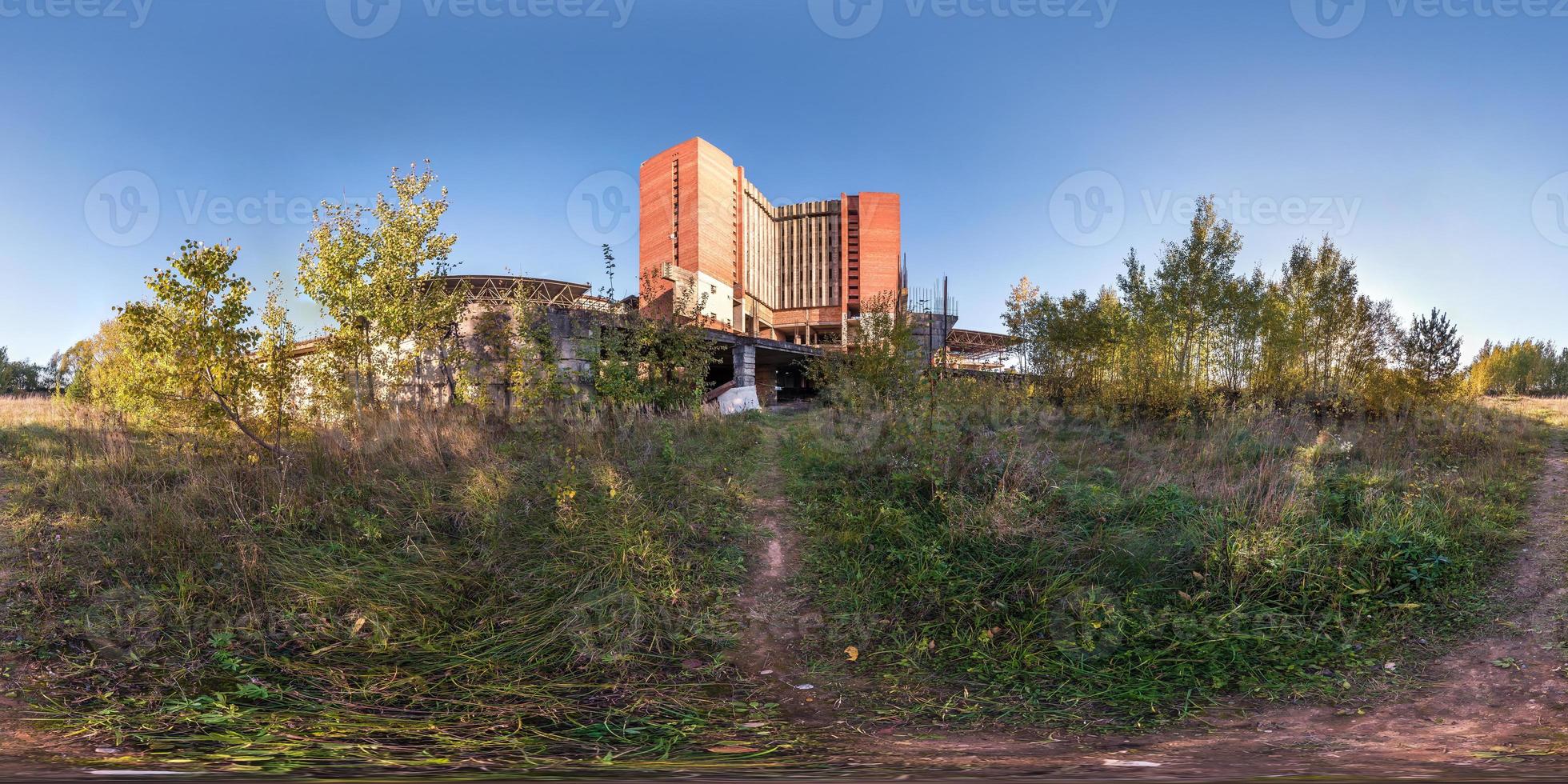 Full spherical seamless panorama 360 degrees angle view near concrete structures abandoned unfinished building of airport. 360 panorama in equirectangular equidistant projection, VR AR content photo