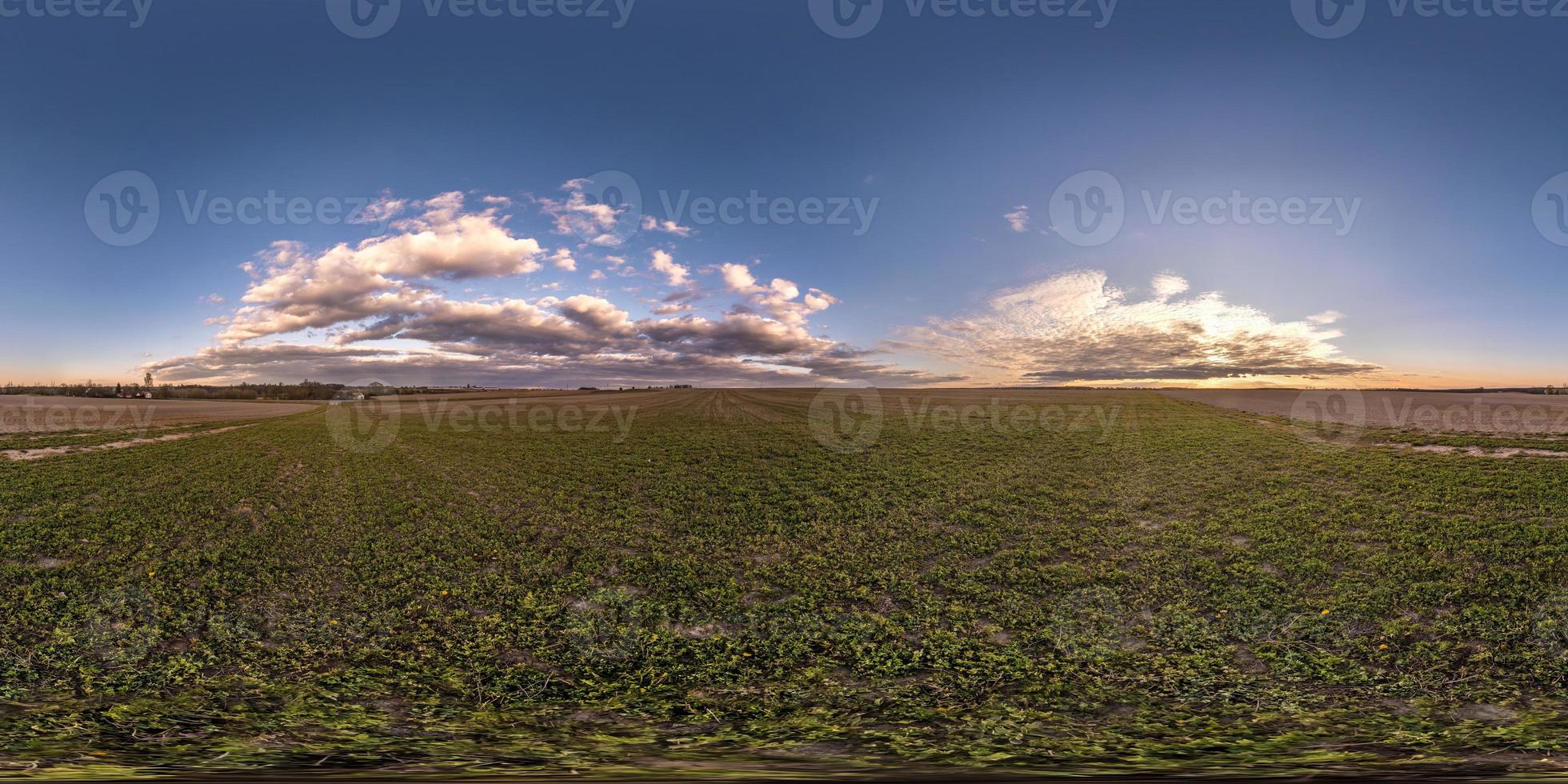 full seamless spherical hdri panorama 360 degrees angle view on among fields in spring evening with awesome clouds in equirectangular projection, ready for VR virtual reality content photo