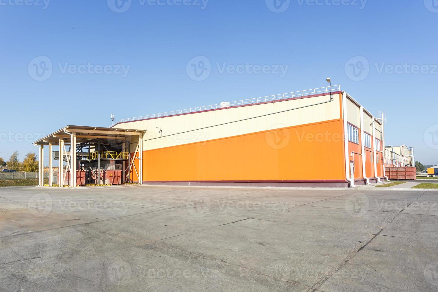 manufacture building of modern waste recycling processing plant in orange style. Separate garbage collection. Recycling and storage of waste for further disposal. photo