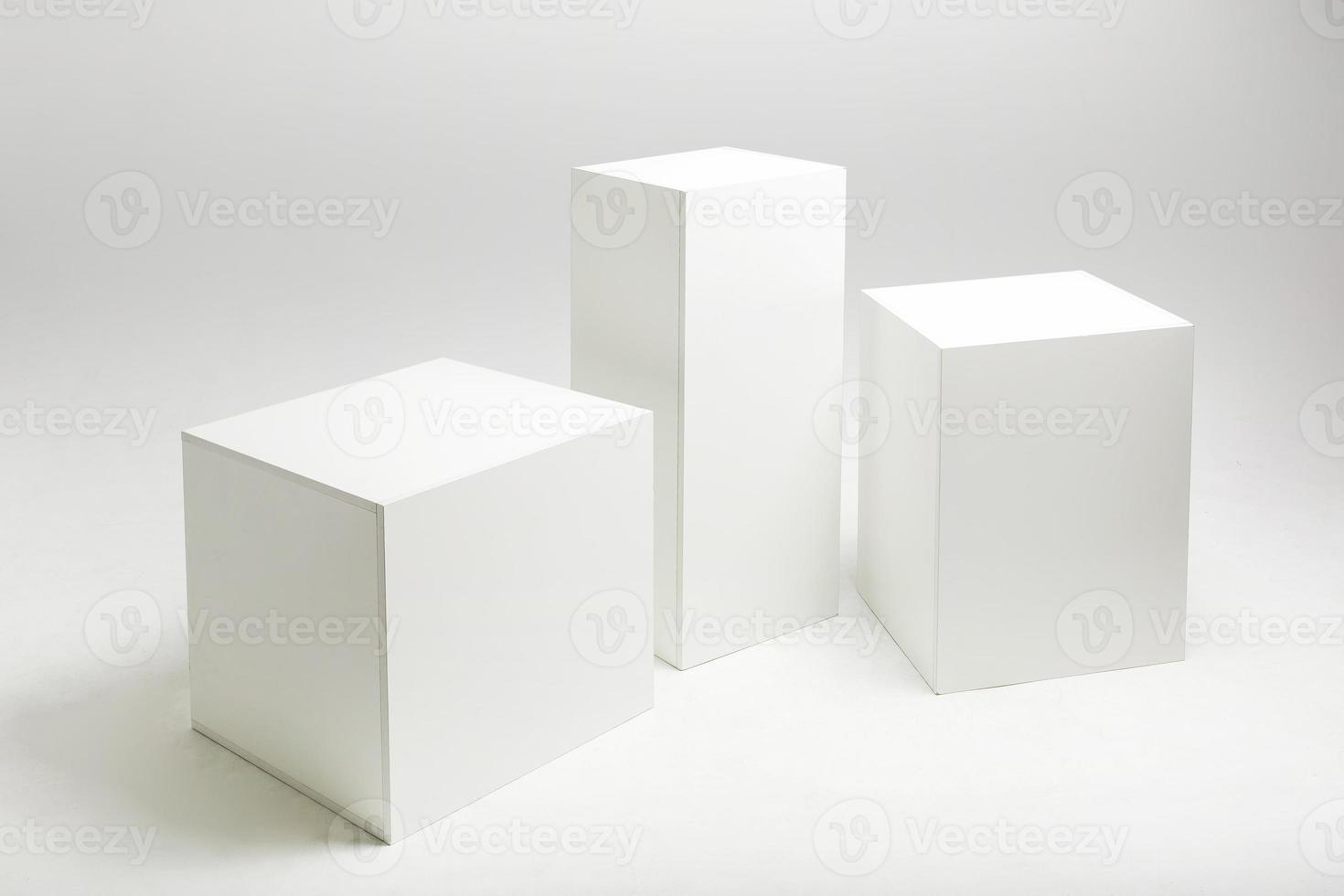 3D illustration of white cubes and parallelepipeds on cyclorama in modern photo studio