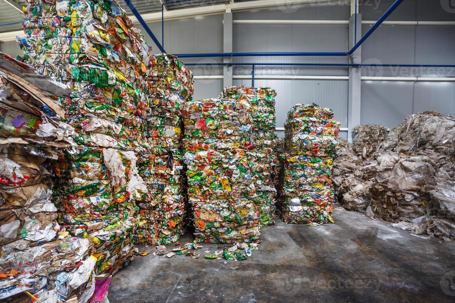 Plastic pressed bales at finished products warehouse on modern waste hazardous processing plant. Separate garbage collection. Recycling and storage of waste for further disposal. photo