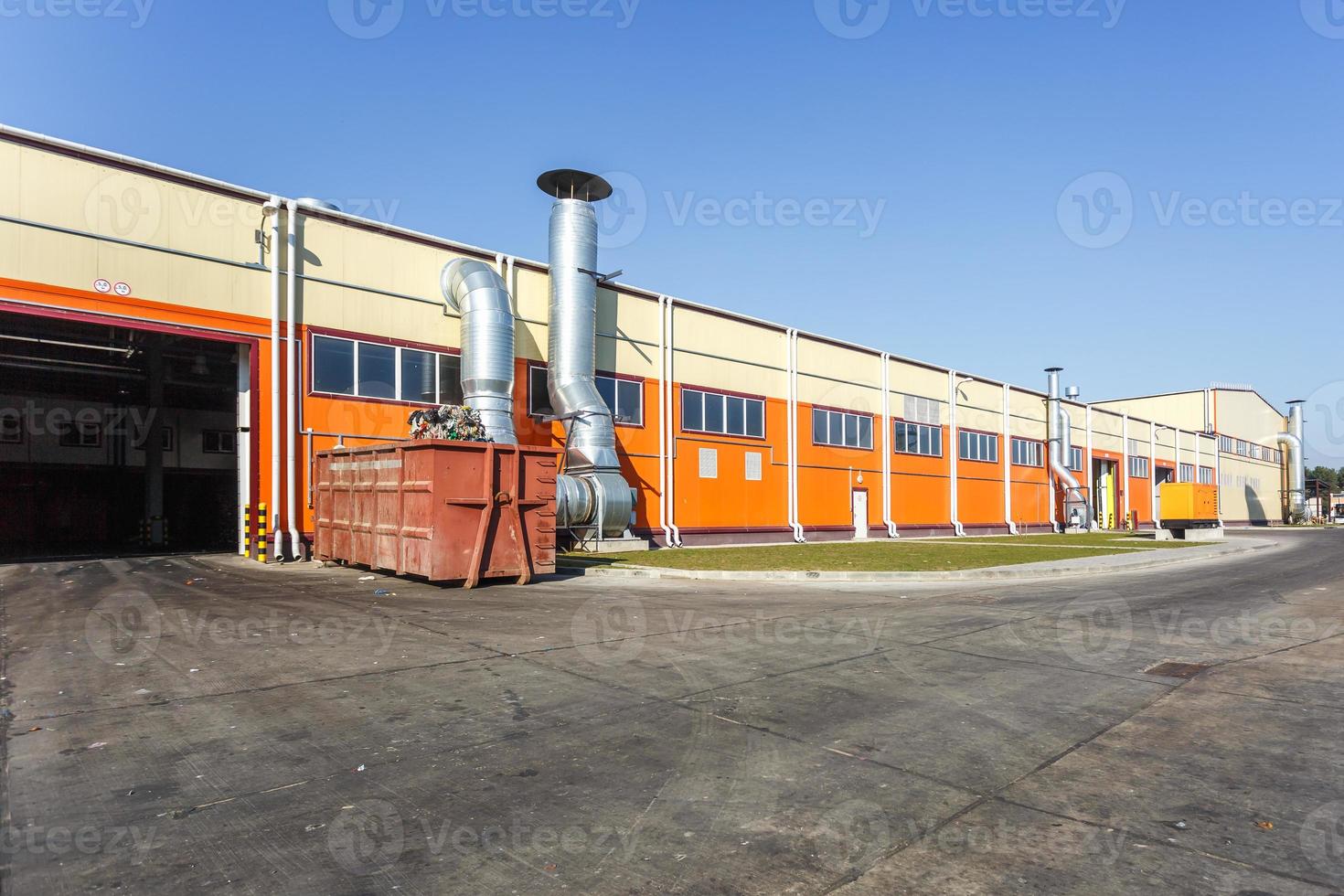 manufacture building of modern waste recycling processing plant in orange style. Separate garbage collection. Recycling and storage of waste for further disposal. photo