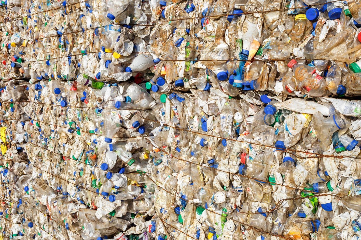 Plastic bales at the waste processing plant. Separate garbage collection. Recycling and storage of waste for further disposal. Business for sorting and processing of waste. photo