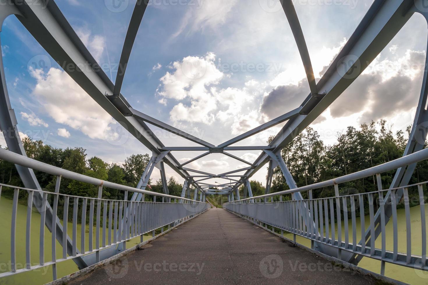 iron steel frame construction of pedestrian bridge across the river photo