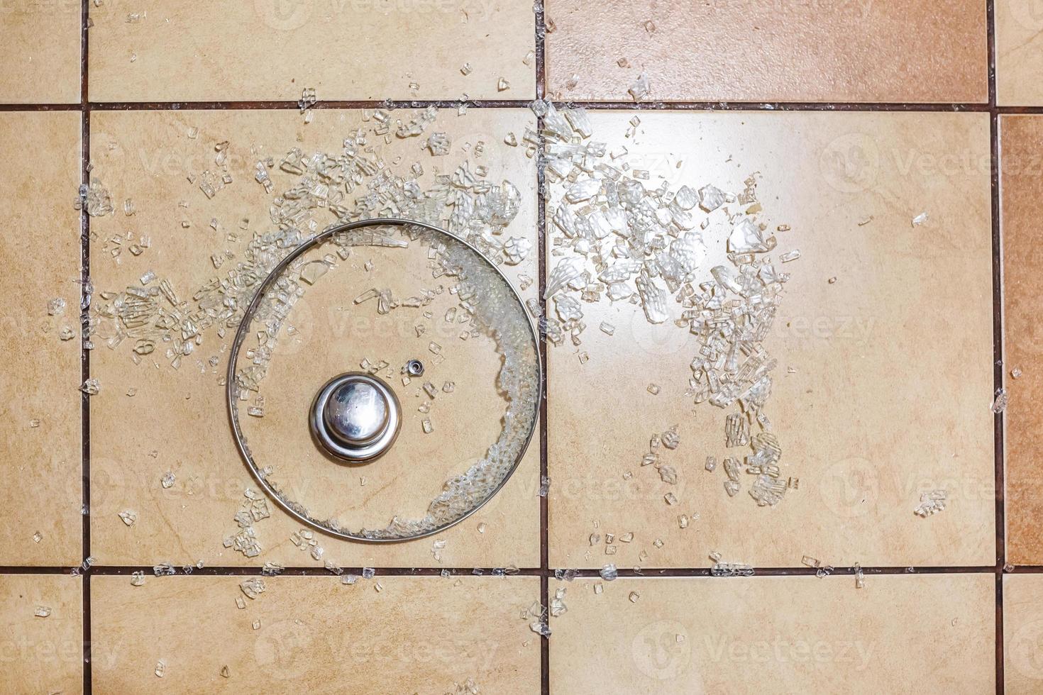 Broken glass lid on the ceramic tiles floor. Family quarrel. Irritation. broken dishes for happiness photo