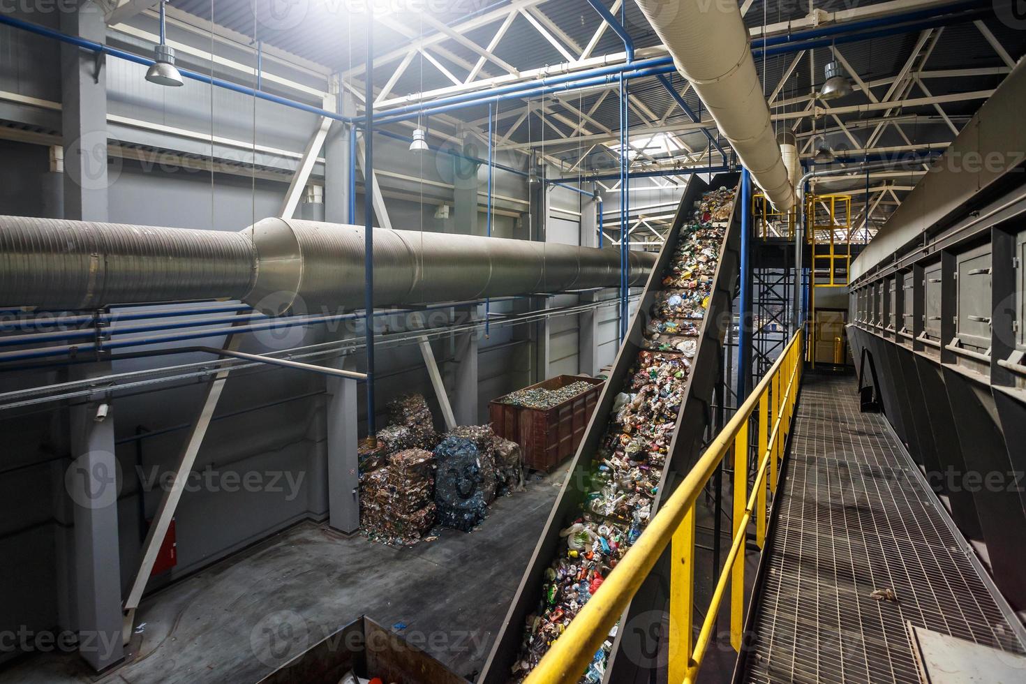 moving conveyor transporter on Modern waste recycling processing plant. Separate and sorting garbage collection. Recycling and storage of waste for further disposal. photo