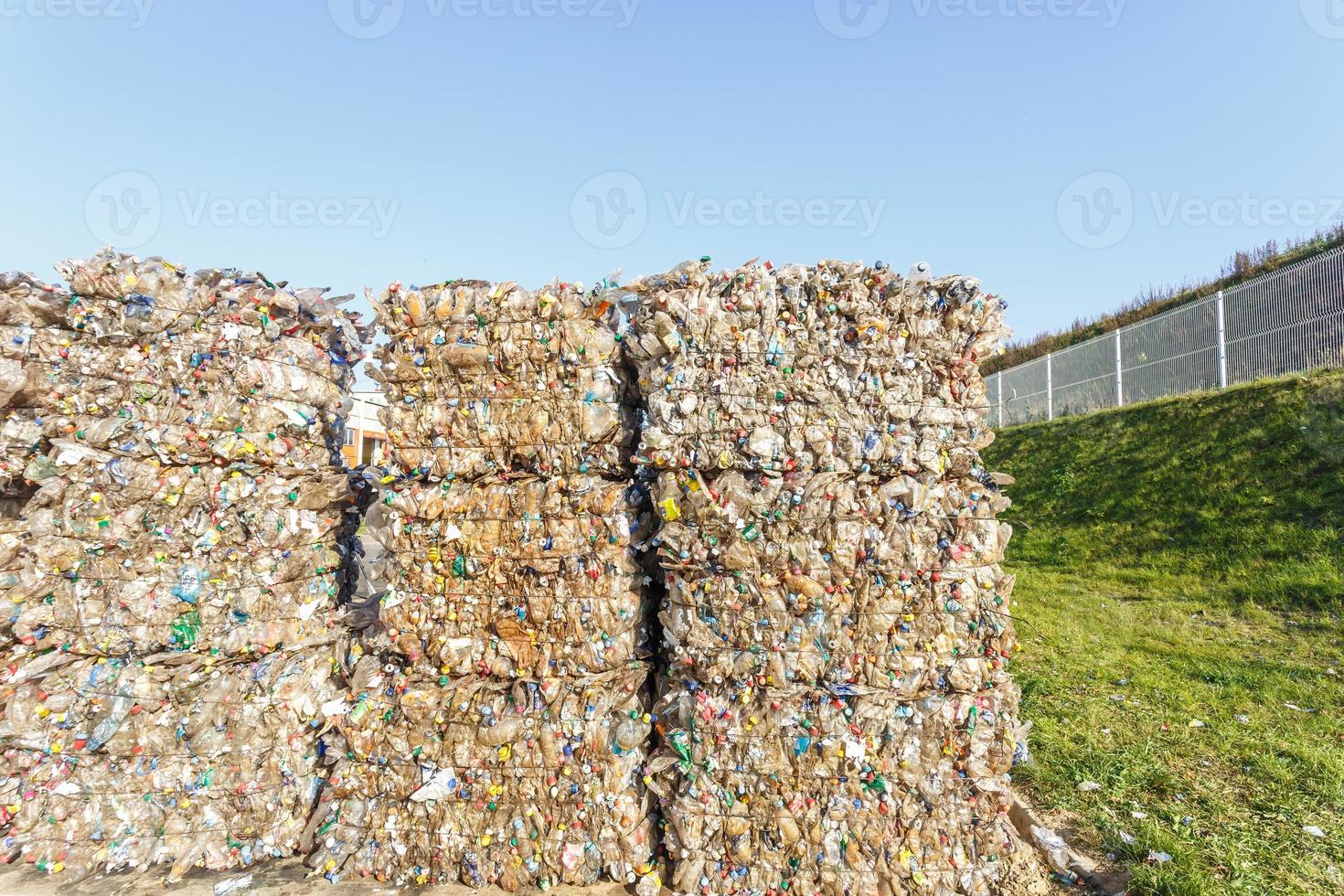Plastic bales of rubbish at the waste treatment processing plant. Recycling separatee and storage of garbage for further disposal, trash sorting. Business for sorting and processing of waste. photo