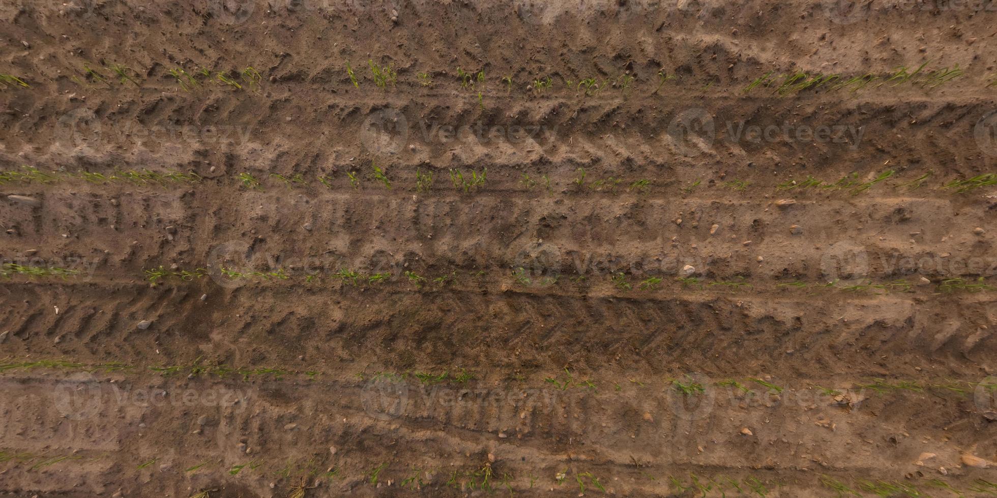 view from above on texture of gravel road with car tire tracks photo