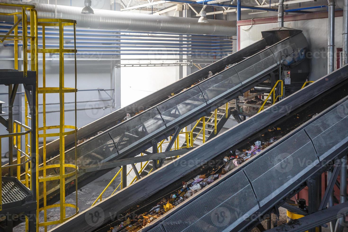 moving conveyor transporter on Modern waste recycling processing plant. Separate and sorting garbage collection. Recycling and storage of waste for further disposal. photo