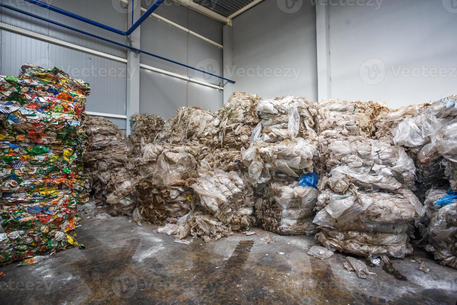 Plastic pressed bales at finished products warehouse on modern waste hazardous processing plant. Separate garbage collection. Recycling and storage of waste for further disposal. photo
