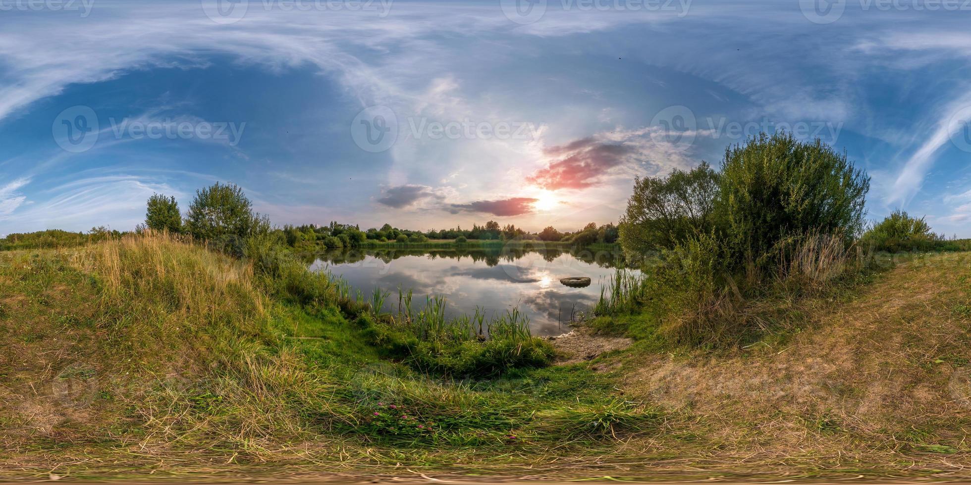 full seamless spherical panorama 360 by 180 angle view on the shore of small lake in sunny summer evening with awesome clouds in equirectangular projection, skybox VR virtual reality content photo