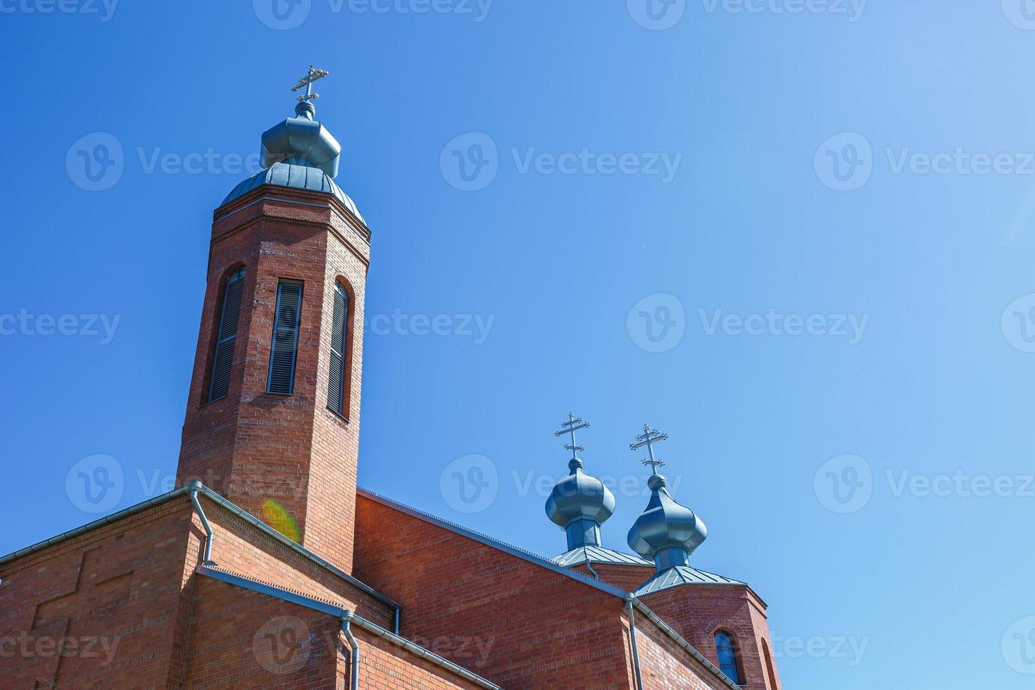 Dome of Orthodox Christian Church of red brick in summer sunny day photo