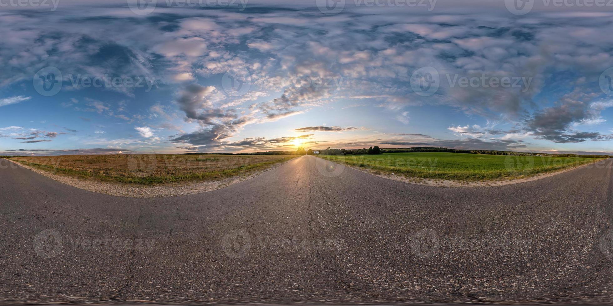 full seamless spherical panorama 360 degrees angle view on asphalt road among fields in summer evening sunset with awesome clouds in equirectangular projection, skybox VR AR virtual reality content photo