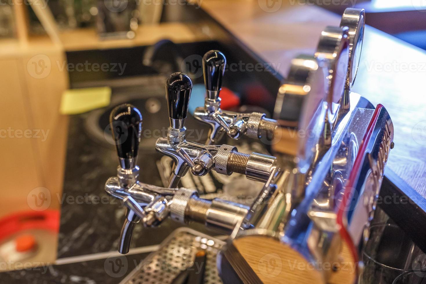 row of cranes for bottled craft beer and drinks in elite bar photo
