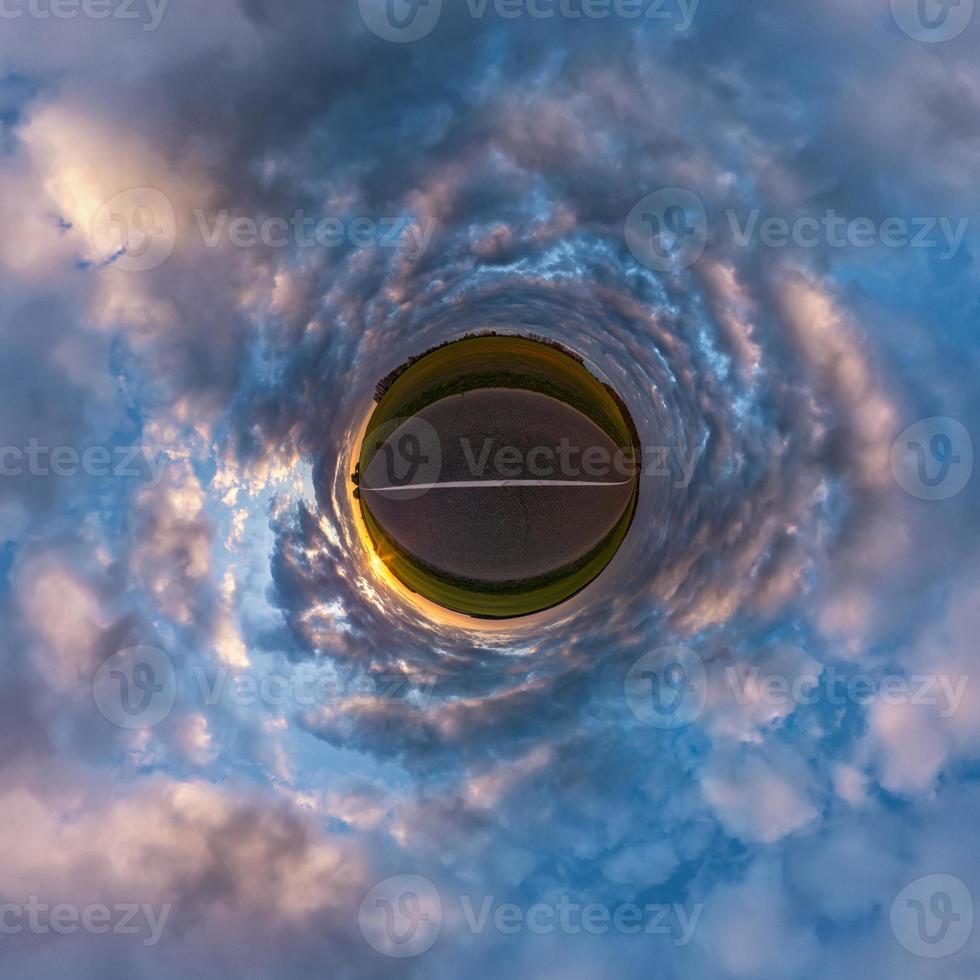 Little planet transformation of spherical panorama 360 degrees. Spherical abstract aerial view in field with awesome beautiful clouds. Curvature of space. photo