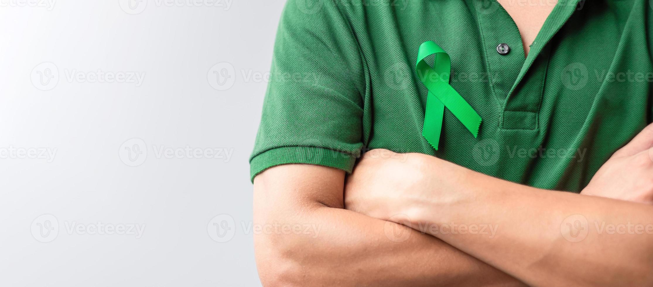 green Ribbon for Liver, Gallbladders, bile duct, cervical, kidney Cancer and Lymphoma Awareness month. Healthcare and world cancer day concept photo