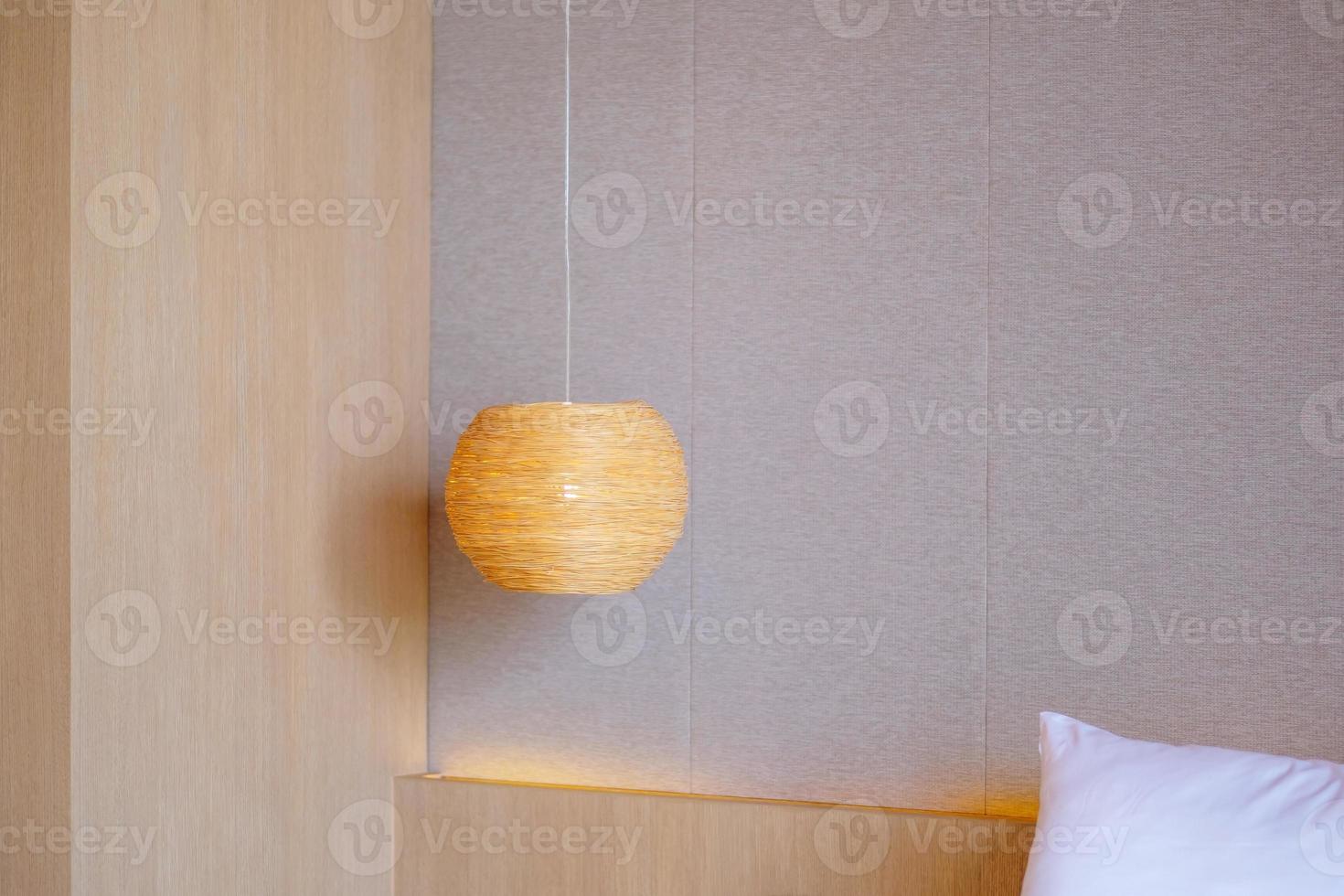 Bamboo lamp hanging in bedroom. Scandinavian, minimal and bohemian style photo