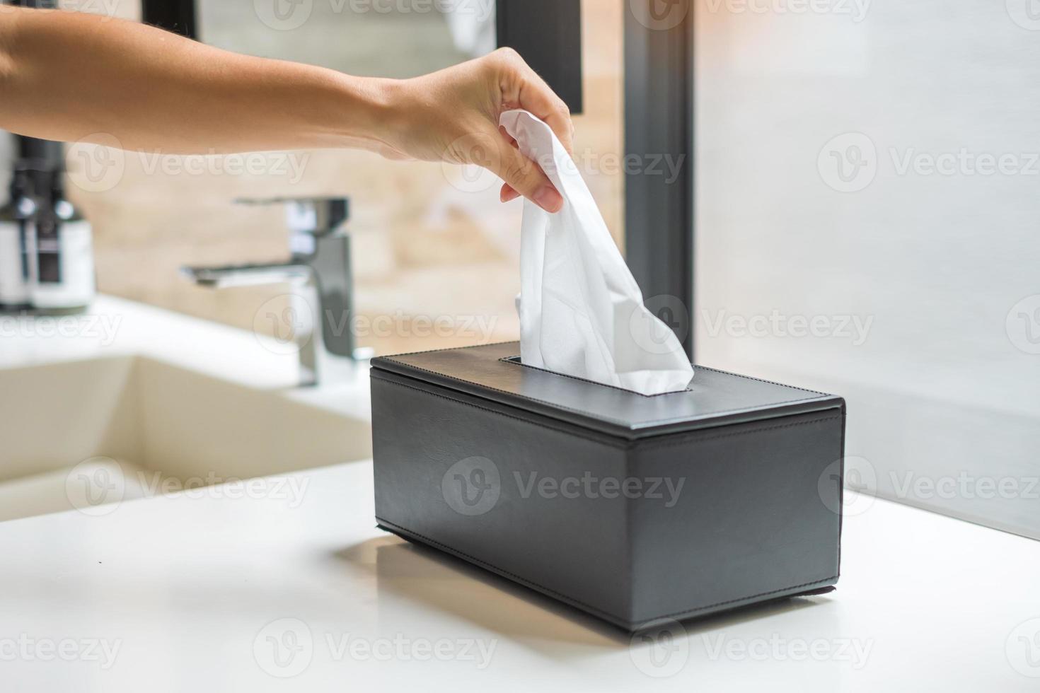 hand pulling toilet paper in bathroom. Cleaning, Lifestyle and personal hygiene concept photo