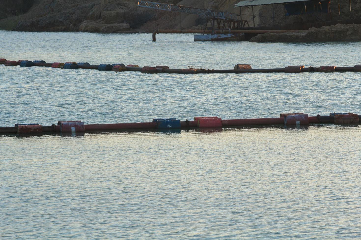 Suction boat's steel pipes are transporting sand from deep rivers for use in the construction of industries such as houses, buildings, roads and many others that use sand as an ingredient. photo