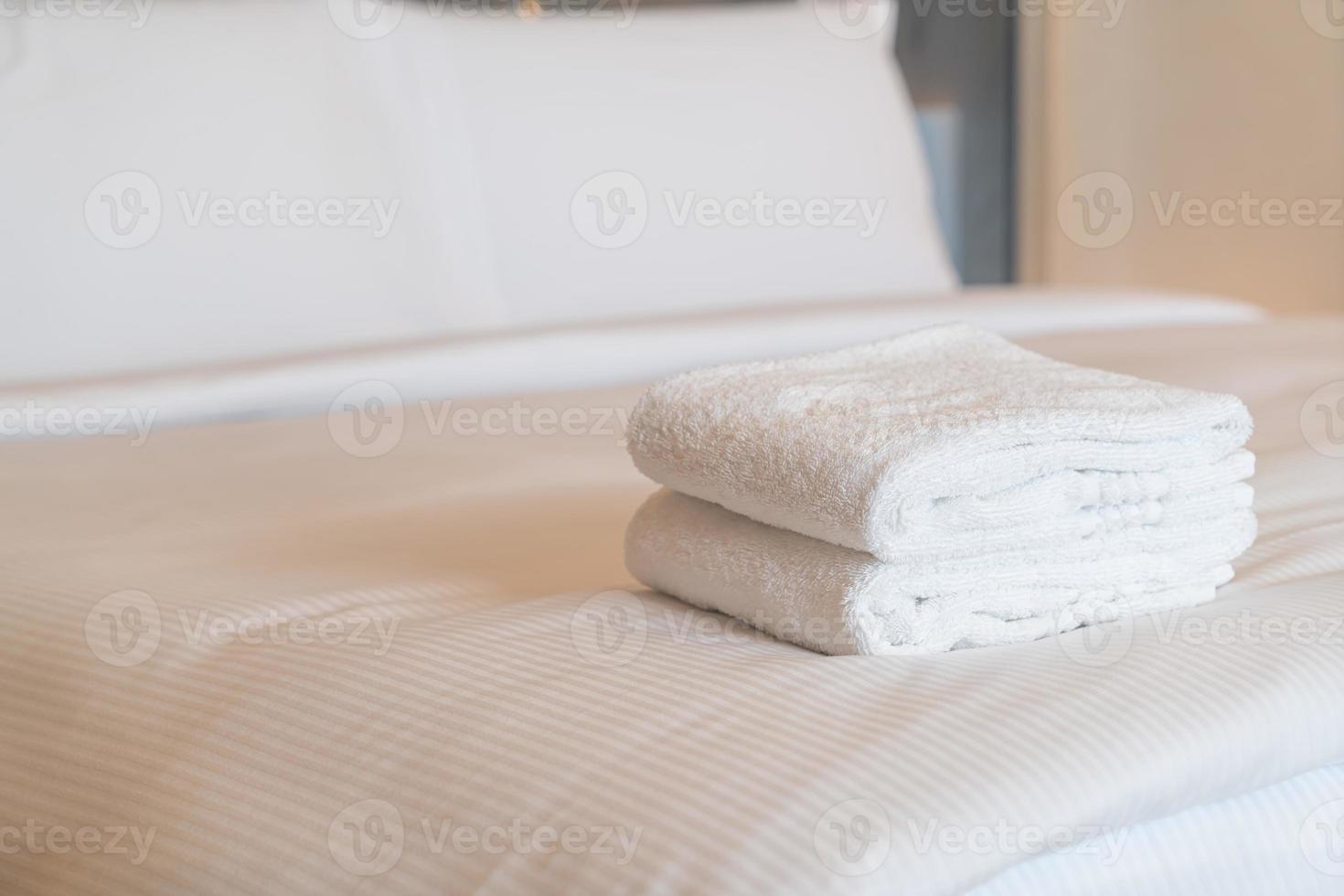 white shower towel on bed photo