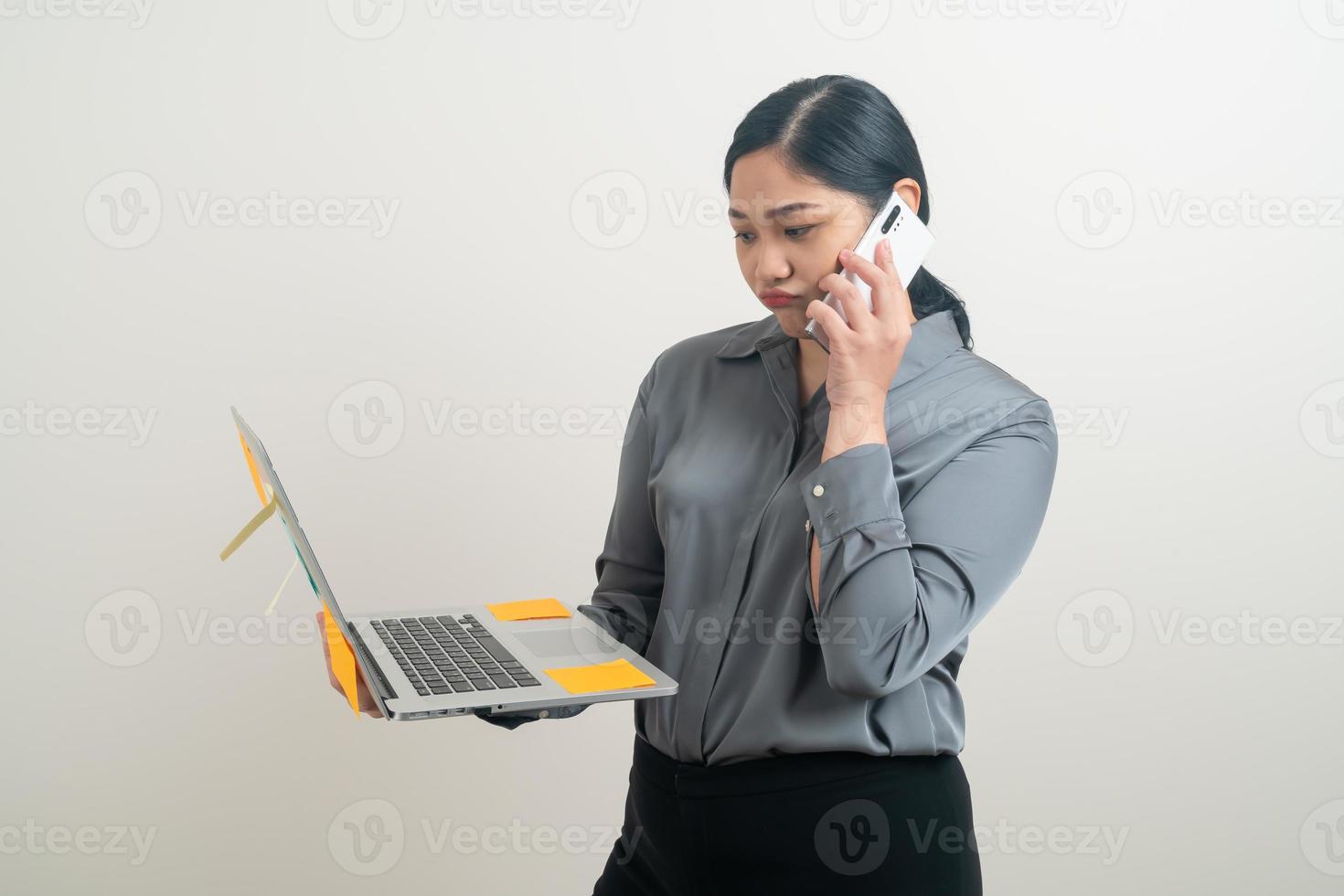 Asian business woman talking telephone with hand holding laptop photo