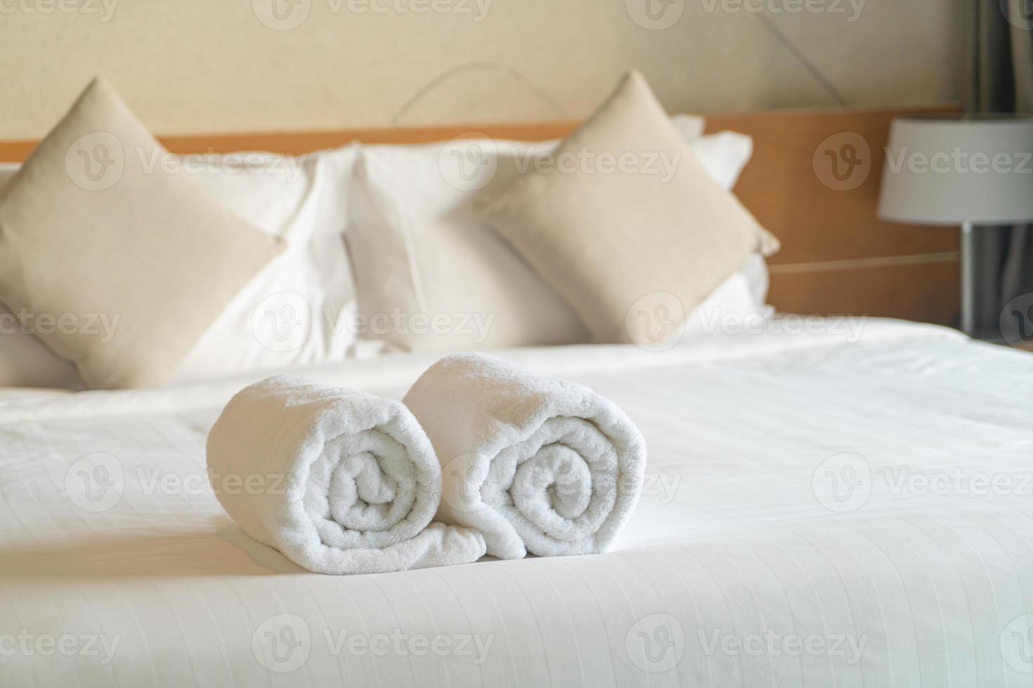 white towel on bed in bedroom photo