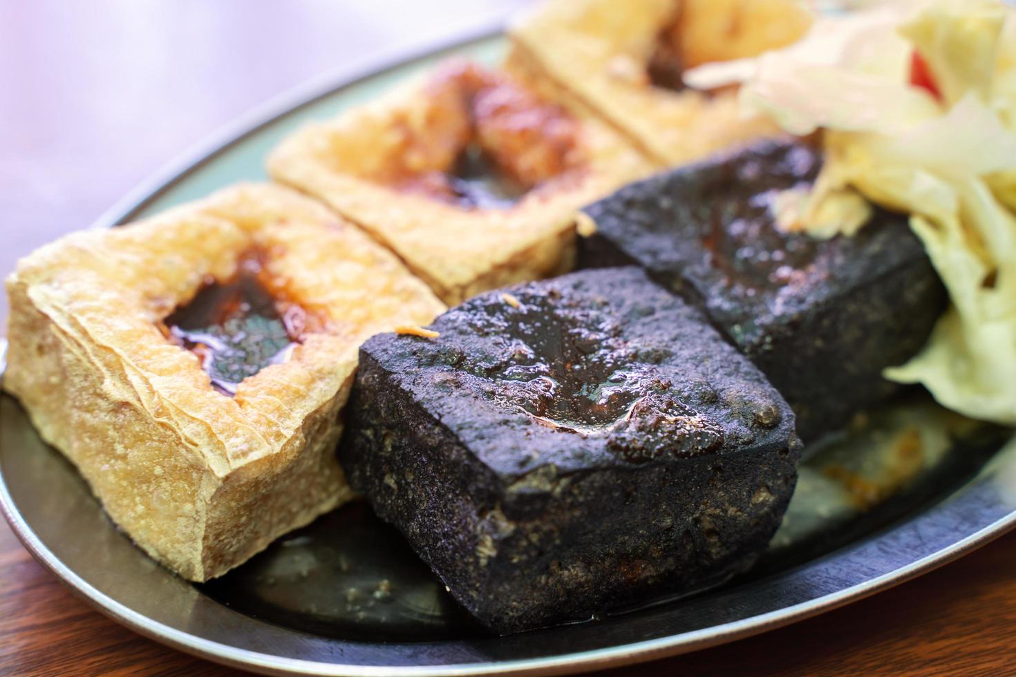 Deep fried stinky tofu with pickled cabbage, famous and delicious street food in Taiwan. photo