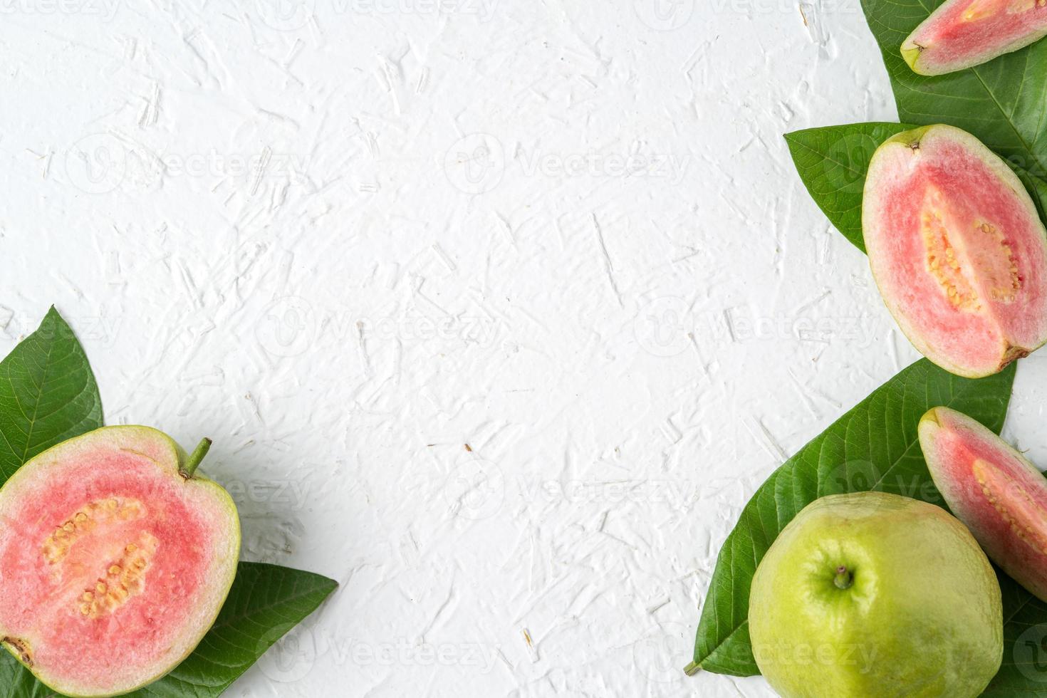 Top view of beautiful red guava with fresh green leaves. photo