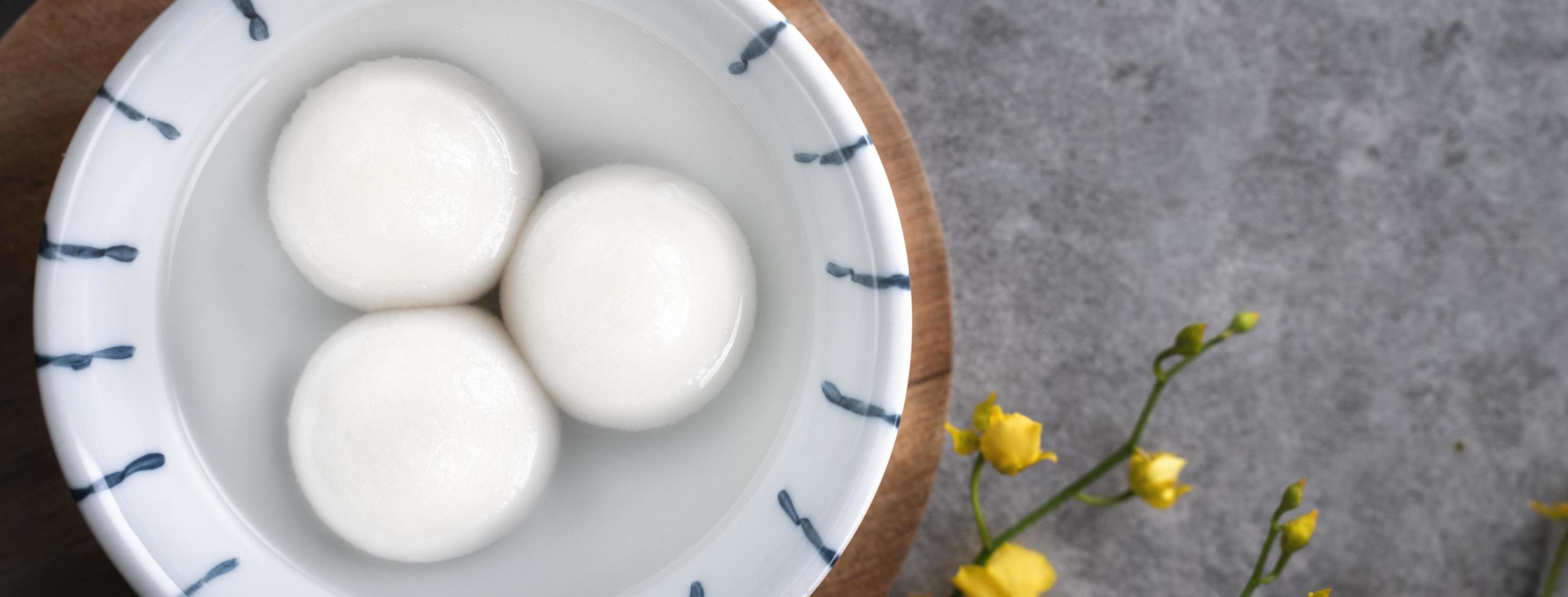 Top view of big tangyuan yuanxiao in a bowl on gray background for lunar new year food. photo