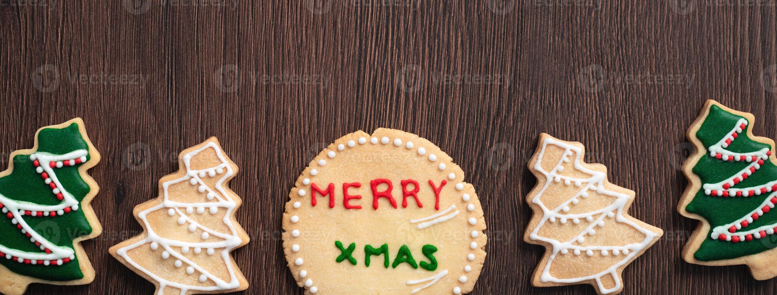 Top view of decorated Christmas tree cookie on wooden table background with copy space. photo
