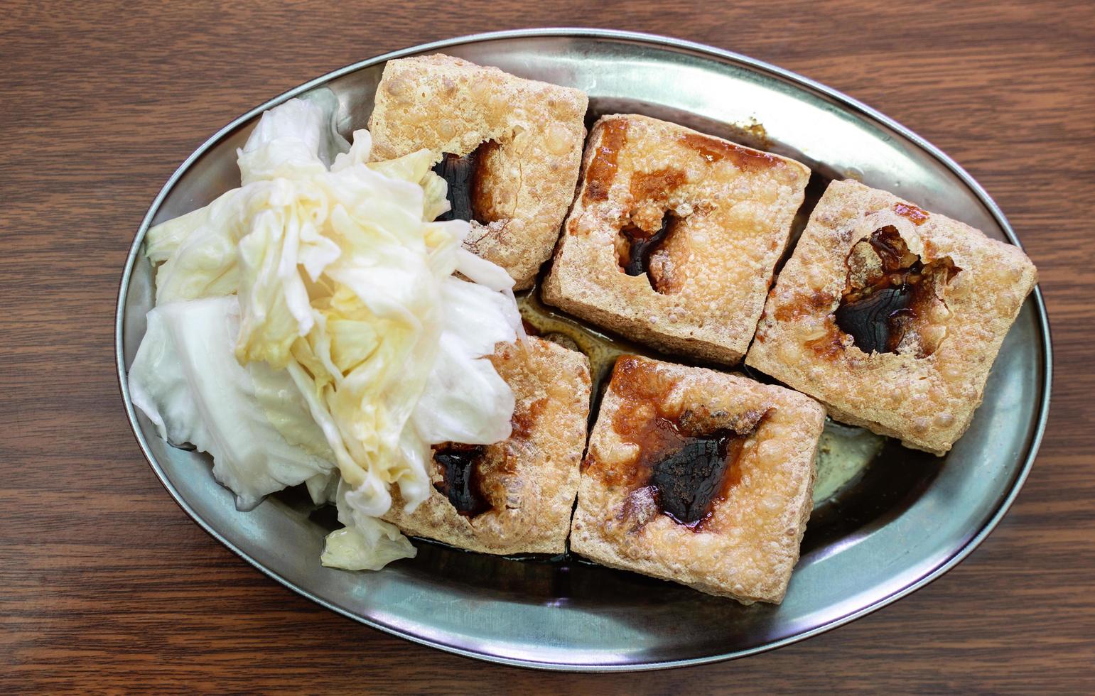 Deep fried stinky tofu with pickled cabbage, famous and delicious street food in Taiwan. photo