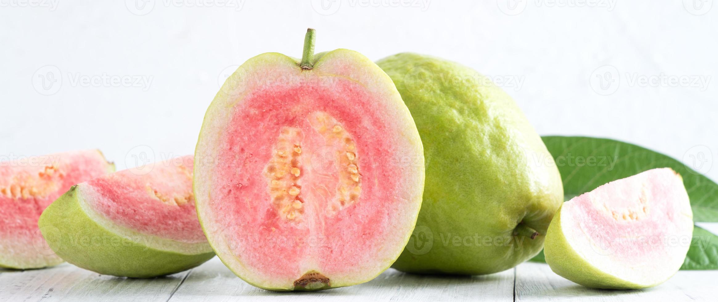 Close up of beautiful red guava with fresh green leaves. photo