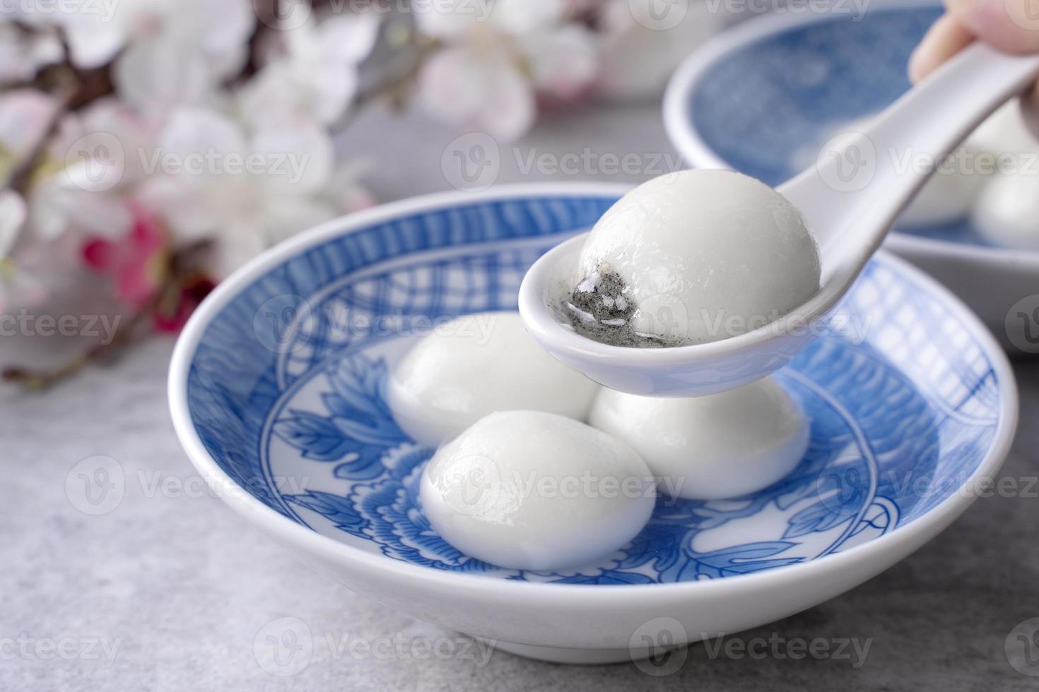 Close up of tangyuan yuanxiao in a bowl on gray table, food for Winter Solstice. photo