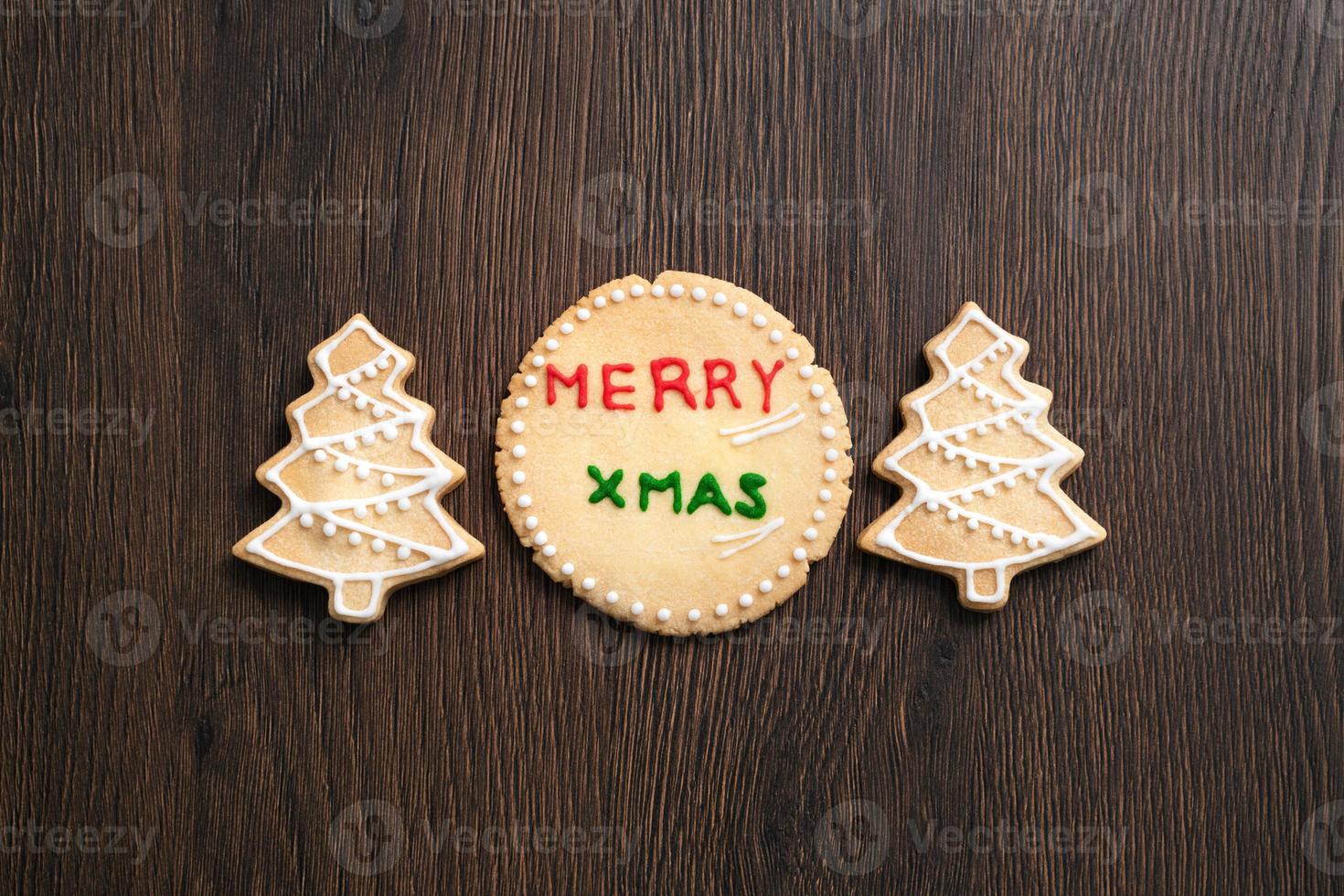 Top view of decorated Christmas tree cookie on wooden table background with copy space. photo