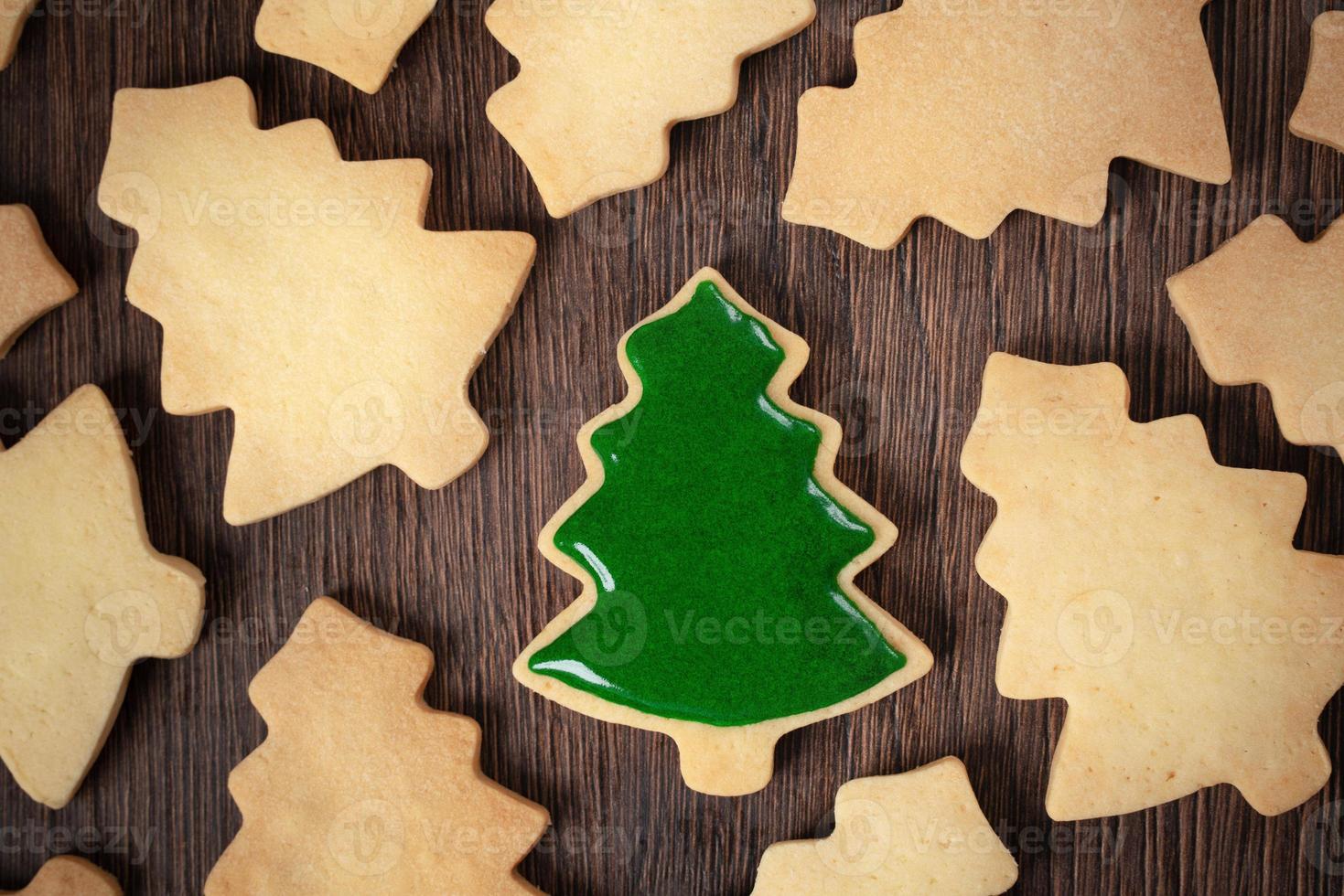 Top view of decorated Christmas tree cookie on wooden table background with copy space. photo