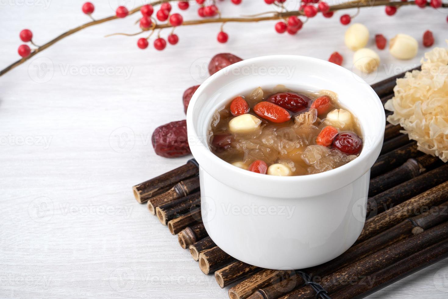 Close up of sweet snow white fungus soup with lotus seed, Chinese red dates and wolfberry. photo