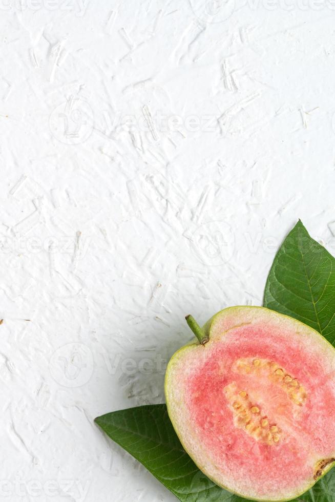 Top view of beautiful red guava with fresh green leaves. photo