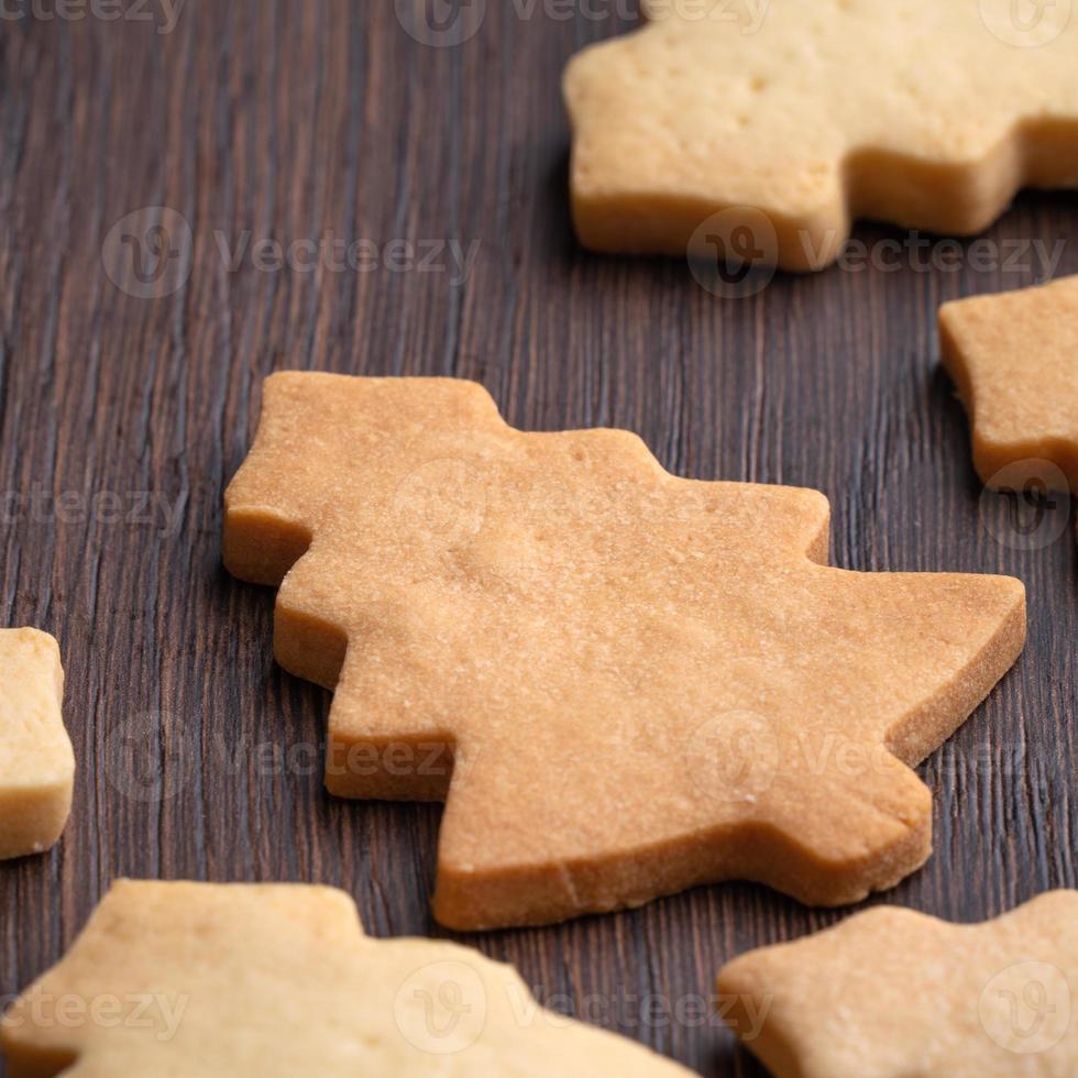 Top view of decorated Christmas tree cookie on wooden table background with copy space. photo