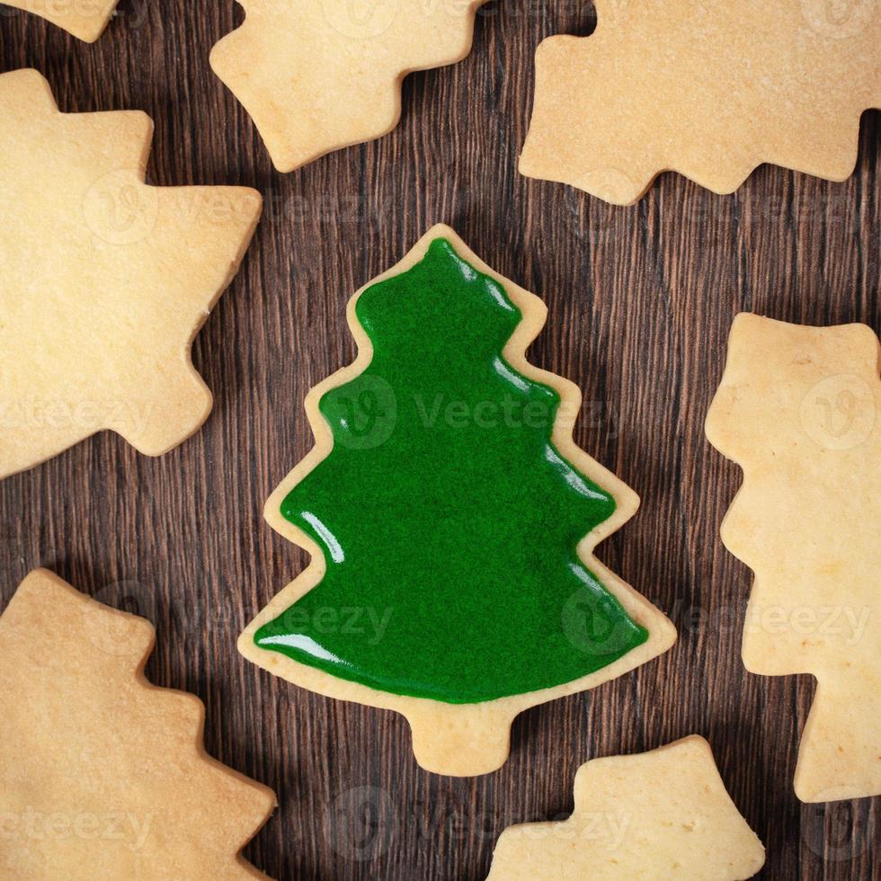 Top view of decorated Christmas tree cookie on wooden table background with copy space. photo